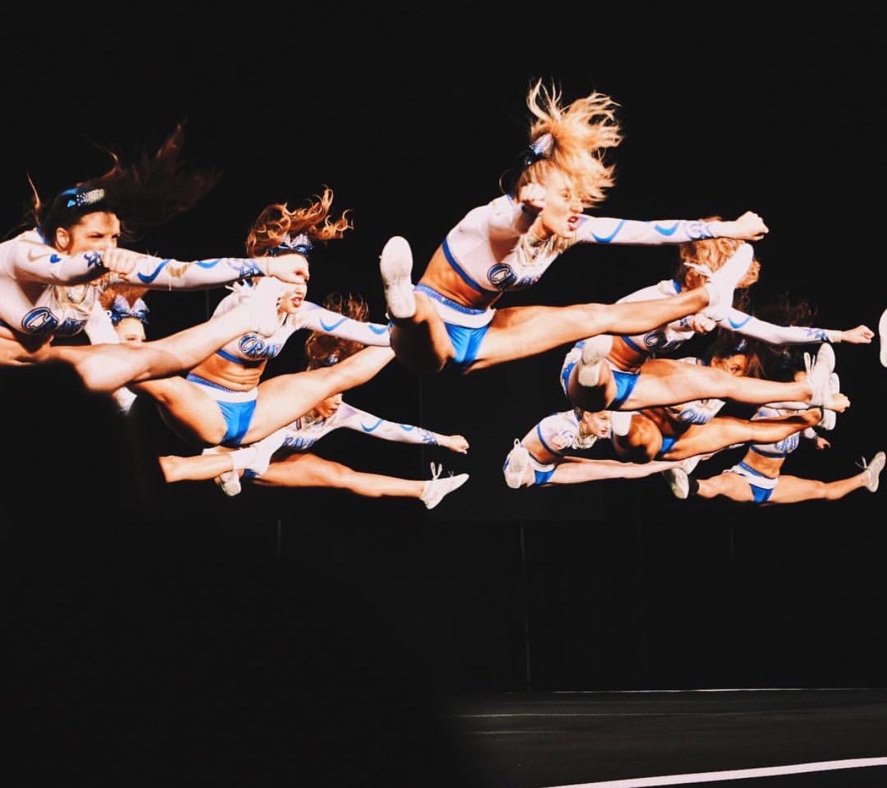 Cheerleaders doing a toe touch